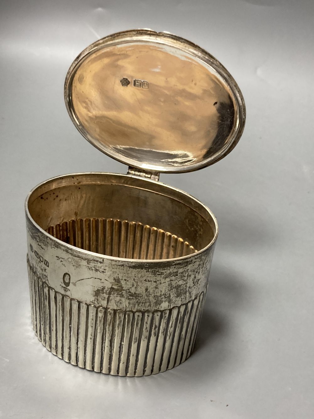 An Edwardian demi fluted silver oval tea caddy, William Hutton & Sons, London, 1909, 82mm, 6.5oz.